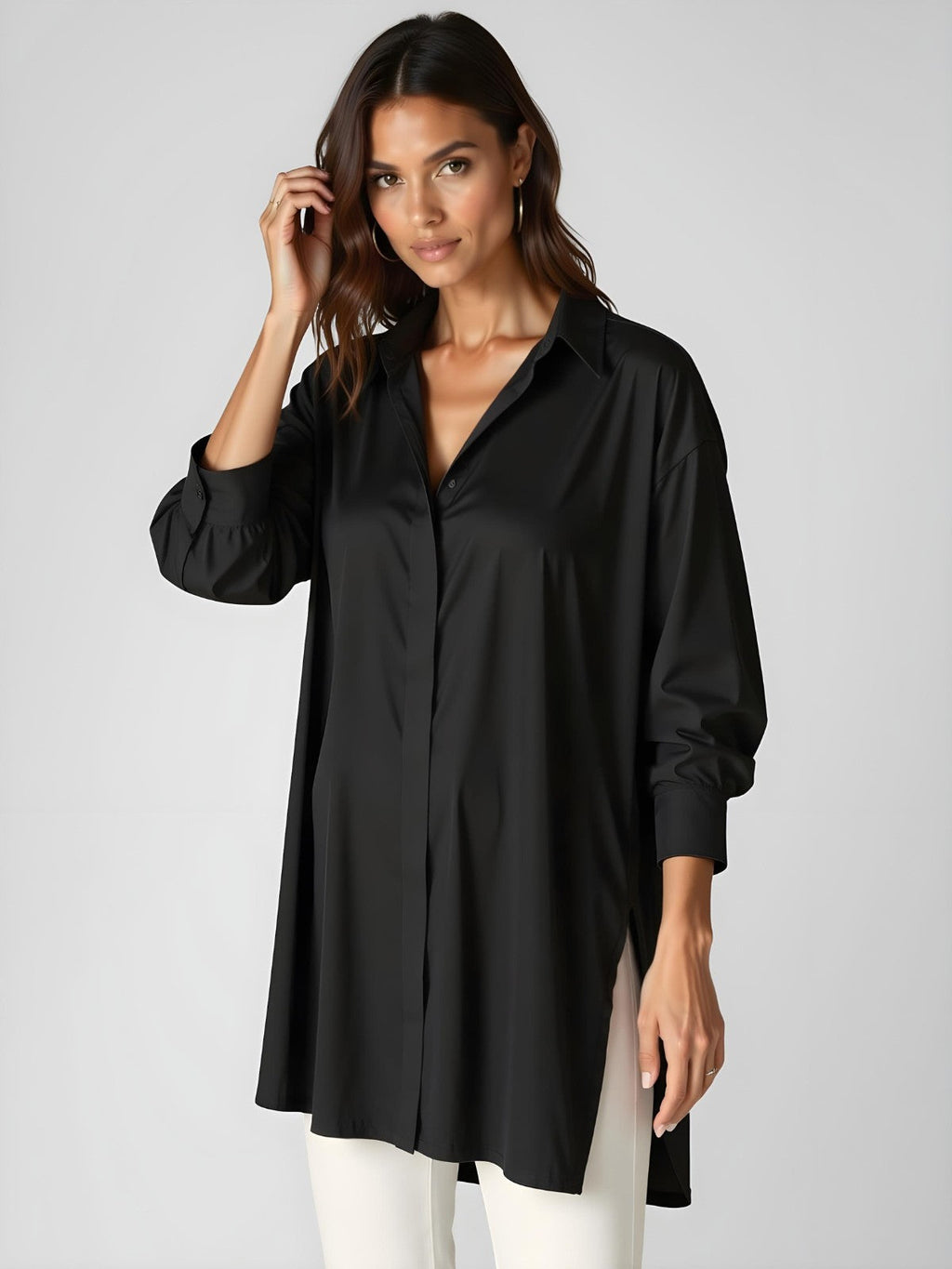 Woman wearing a black buttoned long shirt dress, standing and facing forward to show the fit and style.