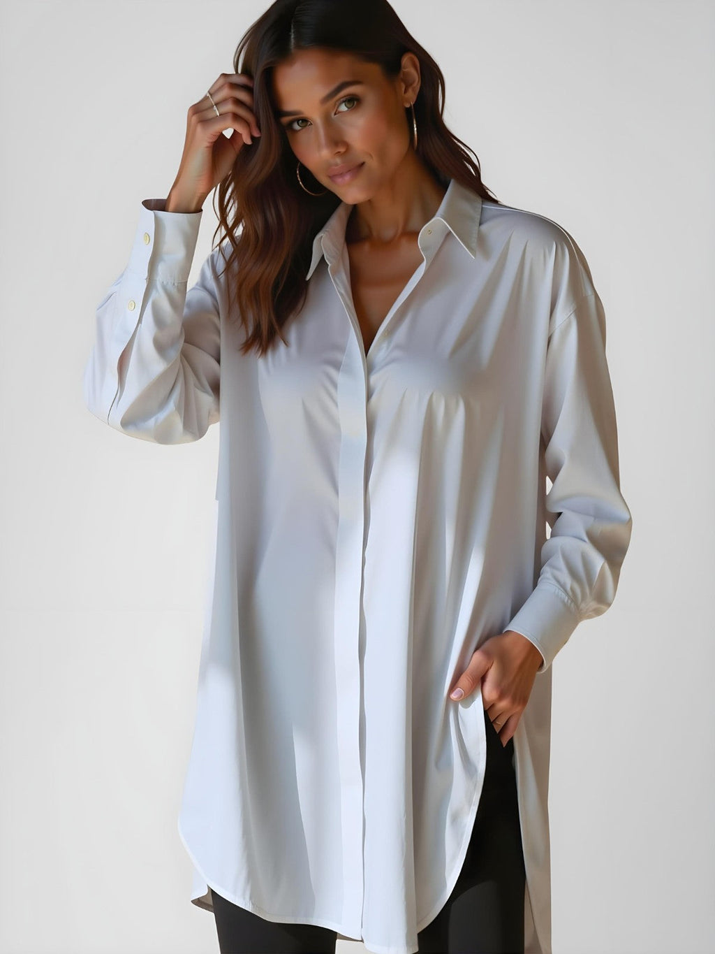 Woman wearing a white buttoned long shirt dress, standing and facing forward to show the fit and style.