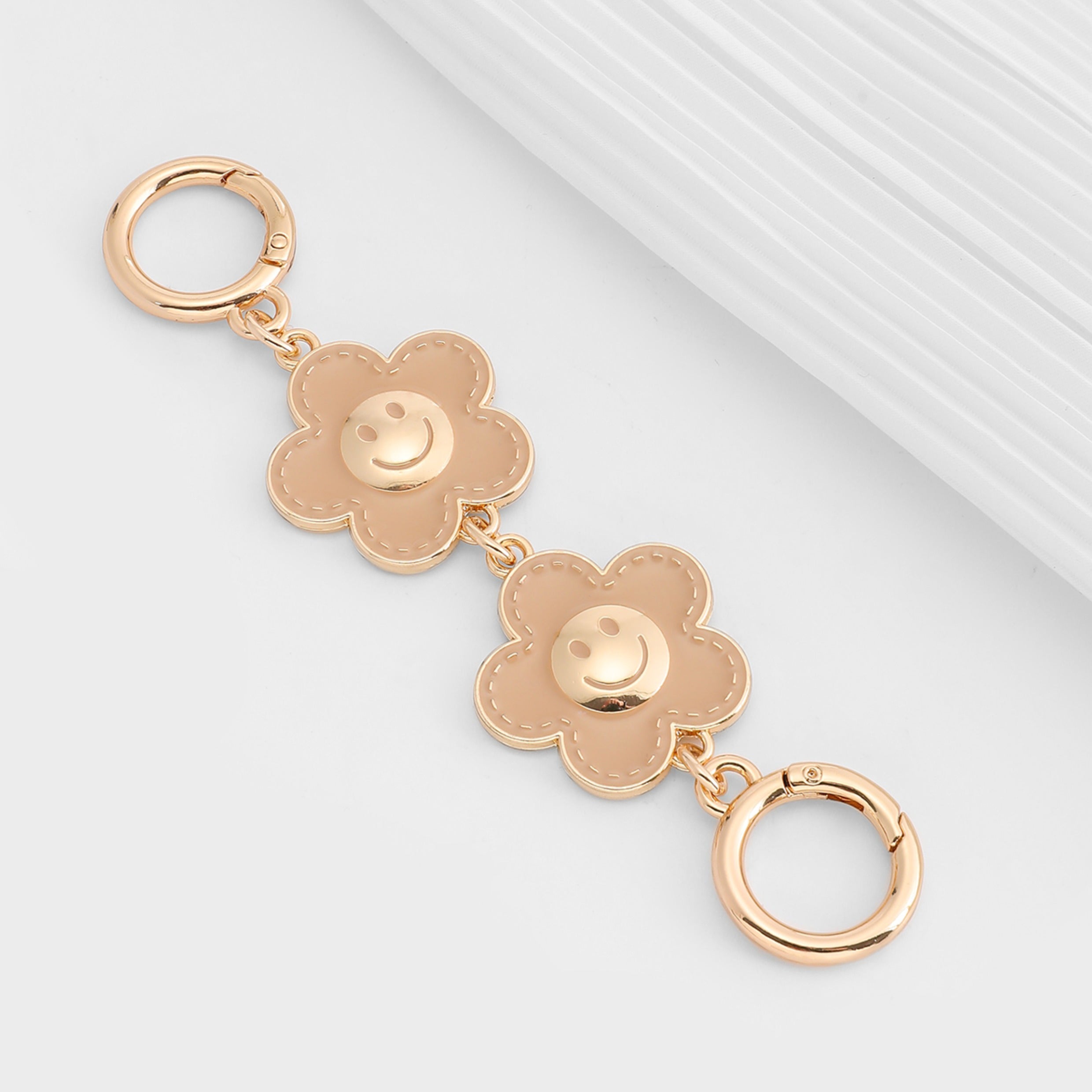 Metal accessory for underarm bags with a flower and smiley face design, 15 cm long strap extension chain