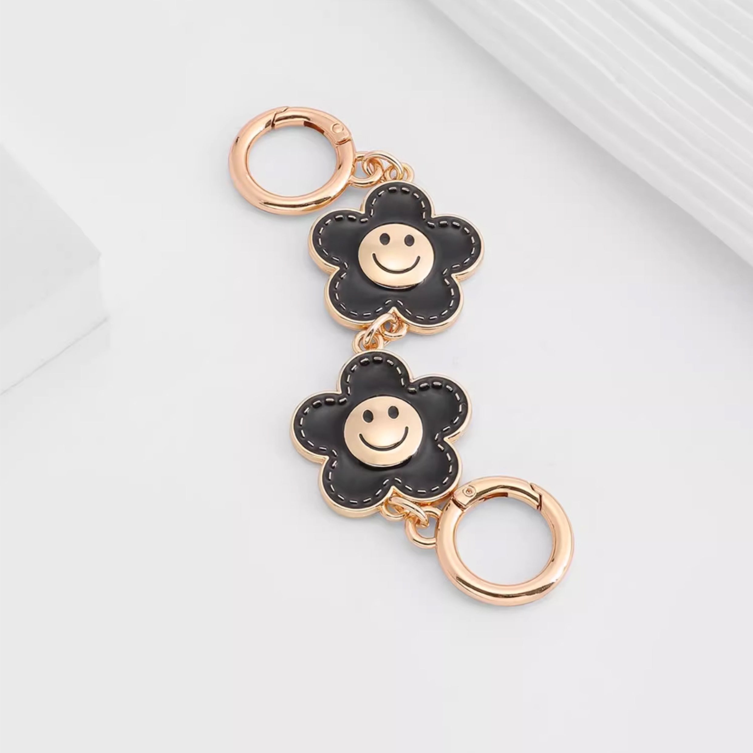 Metal accessory for underarm bags with a flower and smiley face design, 15 cm long strap extension chain