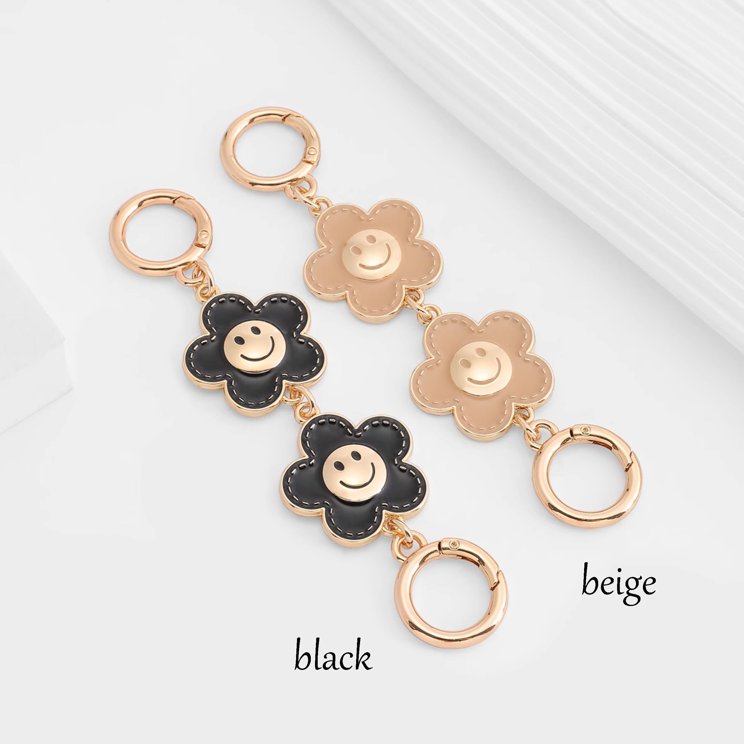 Metal accessory for underarm bags with a flower and smiley face design, 15 cm long strap extension chain